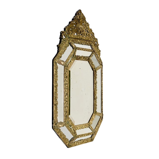 A striking French Napoleon III cushion mirror dating to the 19th century, richly decorated with an elaborate gilt brass...