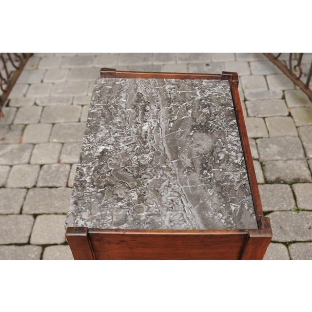 A French walnut tambour door side table from the mid-19th century, with variegated grey marble top and tapered legs. Born...