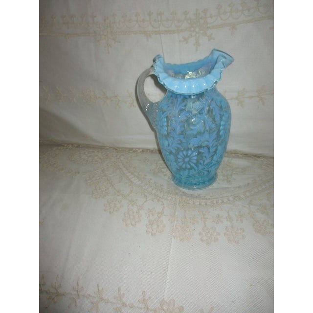 This is a Antique Fenton Water Pitcher in the Beautiful Daisy and Fern Pattern in Opalescent Blue Art Glass that has a...