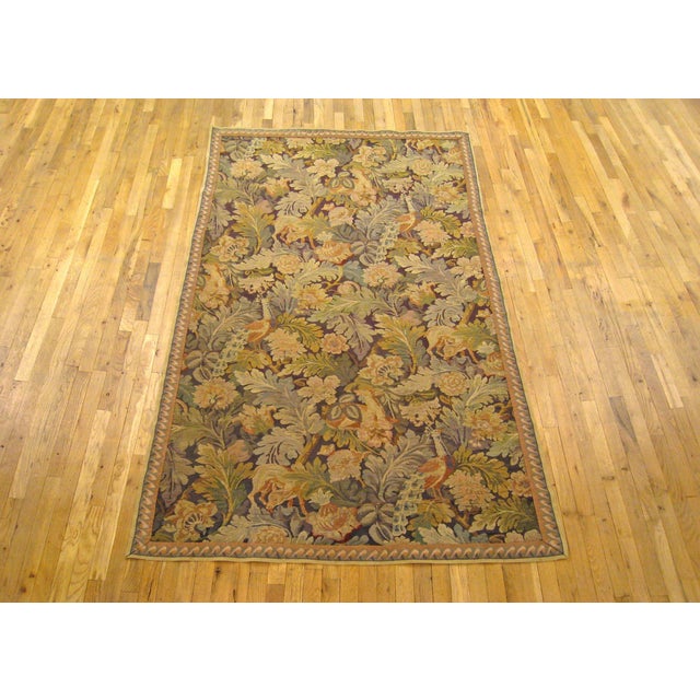 An English William Morris verdure tapestry from the turn of the 20th century, featuring several peacocks within a verdant...