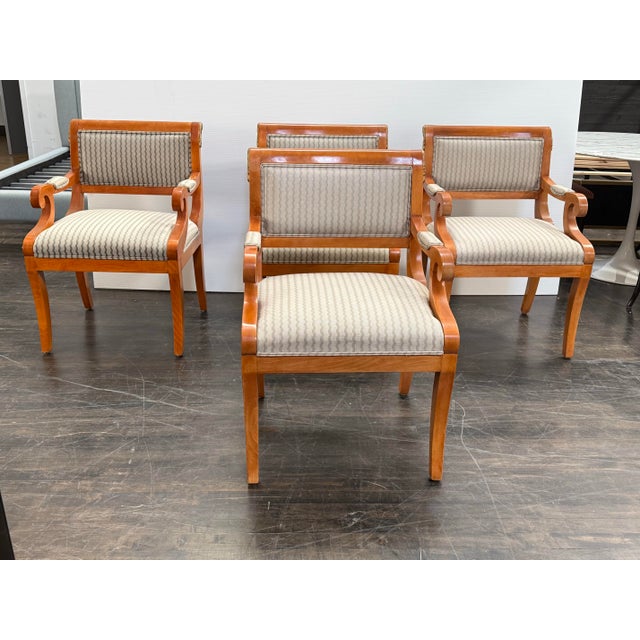 Design Plus Gallery presents a Set of Four Vintage and Neoclassical Influenced Armchairs. The chairs are made from solid...