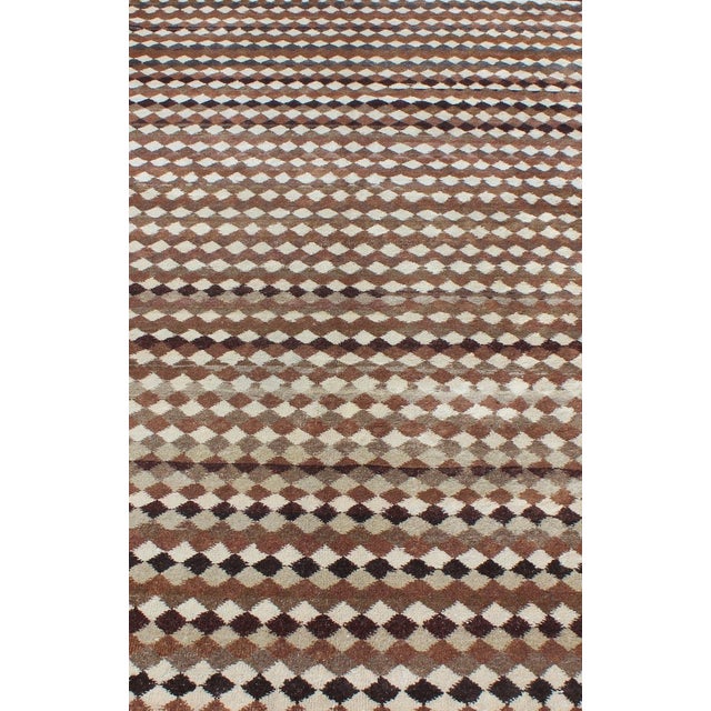 Measures: 5'5 x 9'4. Set on a brown field with an all-over Modern/Mid-Century Modern pattern, this beautiful vintage rug...