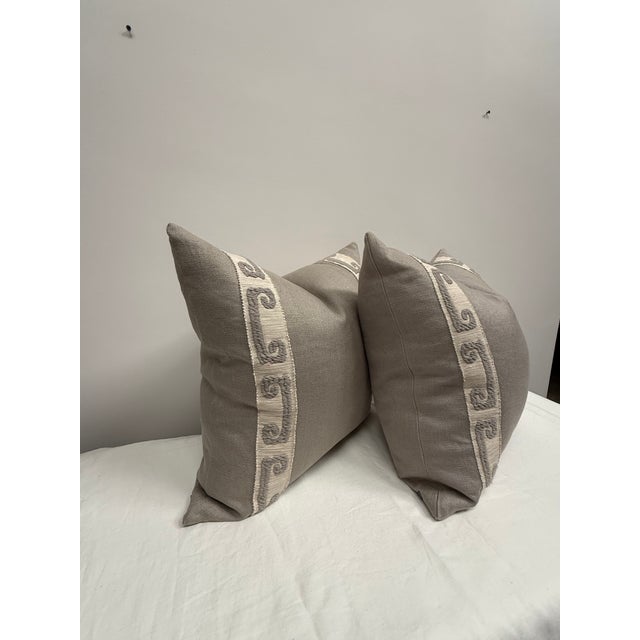 Pair of grey linen pillows with tape trim on one side from Ryan Studio