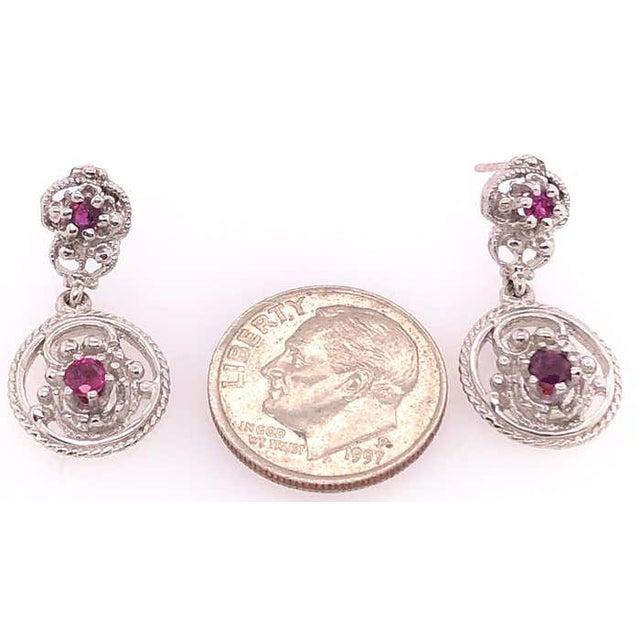 14 Karat White Gold Drop Ruby Earrings. 4 piece round rubies 5 grams total weight.