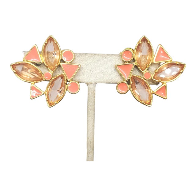 This is part of Chairish’s Costume Jewelry assortment. 1980s goldtone coral enamel and unfoiled openbacked pink marquise...
