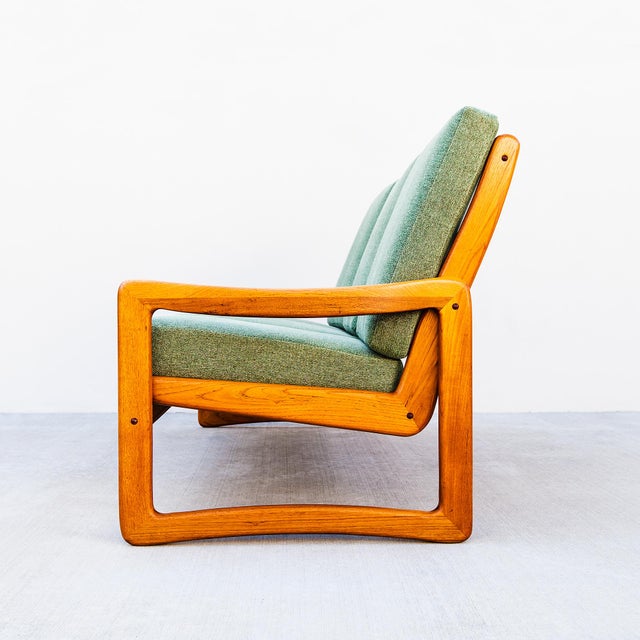 Restored Scandinavian modern solid teak three seater sofa / couch, made by Sun Cabinet Co. The sling-style seat floats...