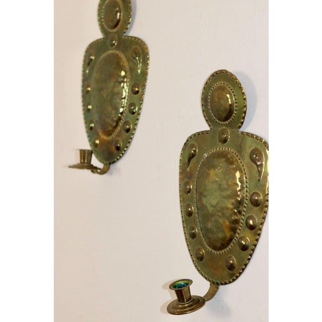 Made in Sweden Mid-century Swedish brass wall sconces, Meticulously handcrafted with embossed designs, the sconce...