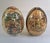 A beautiful vintage pair of Satsuma‑style porcelain decorative eggs, each hand‑painted with colorful figural scenes,...