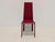 Elegant kristalia designer dining chairs, upholstered entirely in a rich deep-red leather. The chairs feature a...