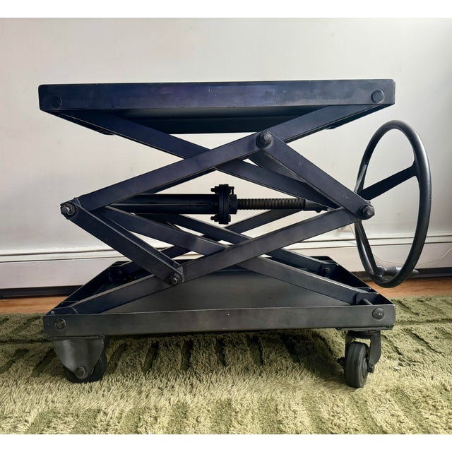 Highly sought after discontinued Restoration Hardware scissor lift table in black steel. Max height: 42.5” Min height: 14”...