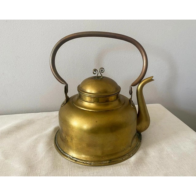 Rustic brass plated tea kettle with a copper handle, purchased at a flea market in Belgium in the 1960s. This large tea...