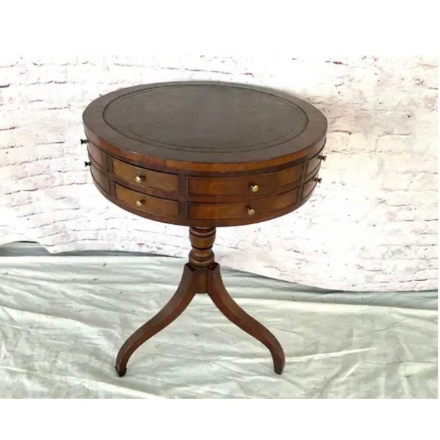 English Regency Drum Table with Leather Inset Top. Table's circular form is elegantly proportioned, resting on turned...