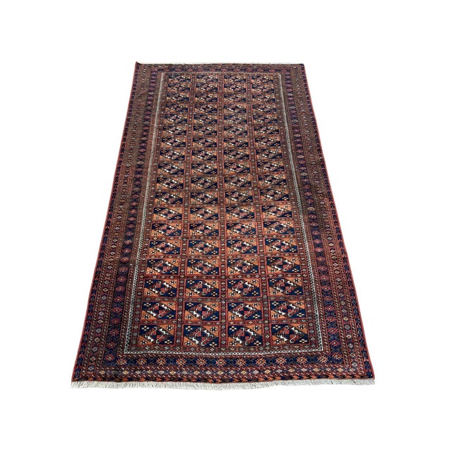 Vintage Afghan Turkmen rug, hand knotted in Afghanistan from 100% wool. Measuring 3’8” x 6’7”, this traditional tribal rug...