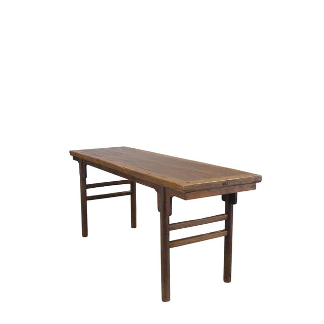 Constructed from solid elm, this classic recessed-leg table (pingtou'an) features a flush-sided rectangular top with a...