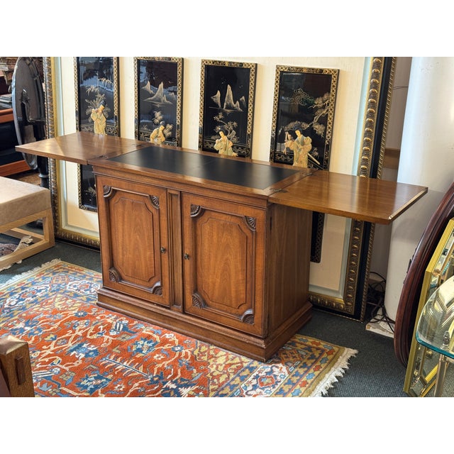 Design Plus Gallery presents a Walnut Wood Buffet with a Flip Top White Fine Furniture. The buffet/bar has a rectangular...