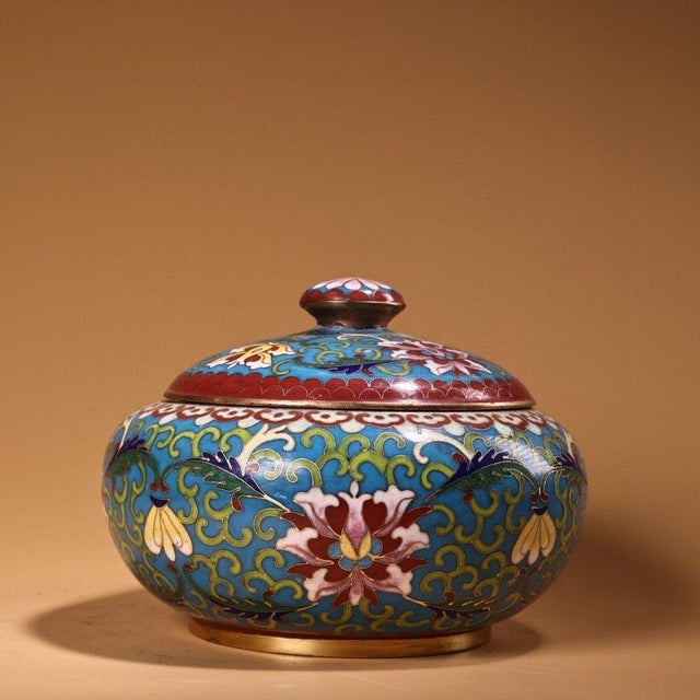 This is a charming vintage Chinese cloisonné enamel lidded jar, crafted from a copper body . The jar features a bulbous,...
