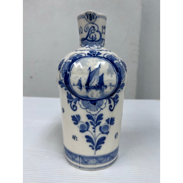 Design Plus Gallery presents a Vintage Bols Delft Blue Decanter Jug. Features the classic blue and white style associated...