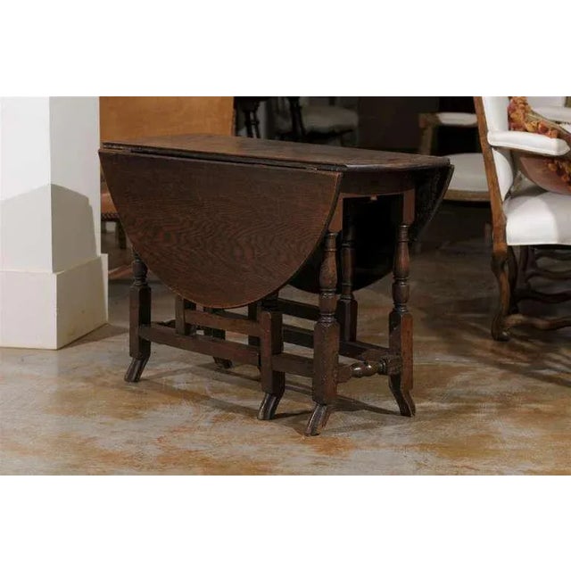 An English 18th century oak oval gateleg drop-leaf table with unusual drake feet. Born in the second half of the 18th...