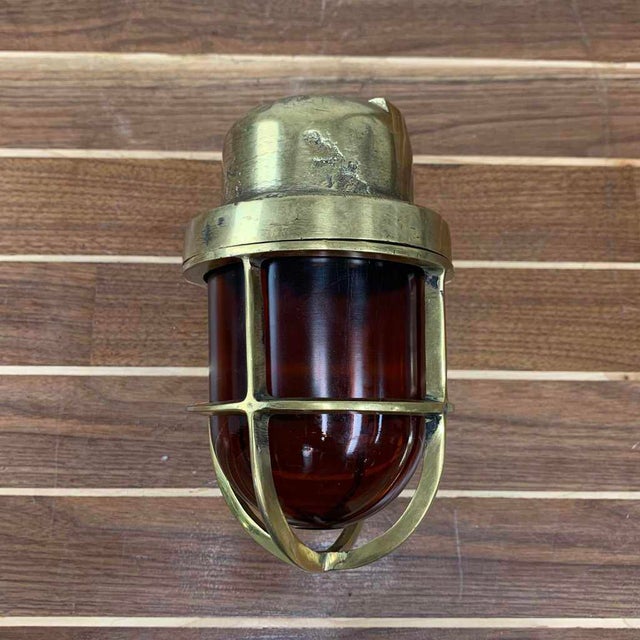 This Amber Glass Cast Brass Wall Light once guided crew through ship passageways. We salvaged it from a decommissioned...