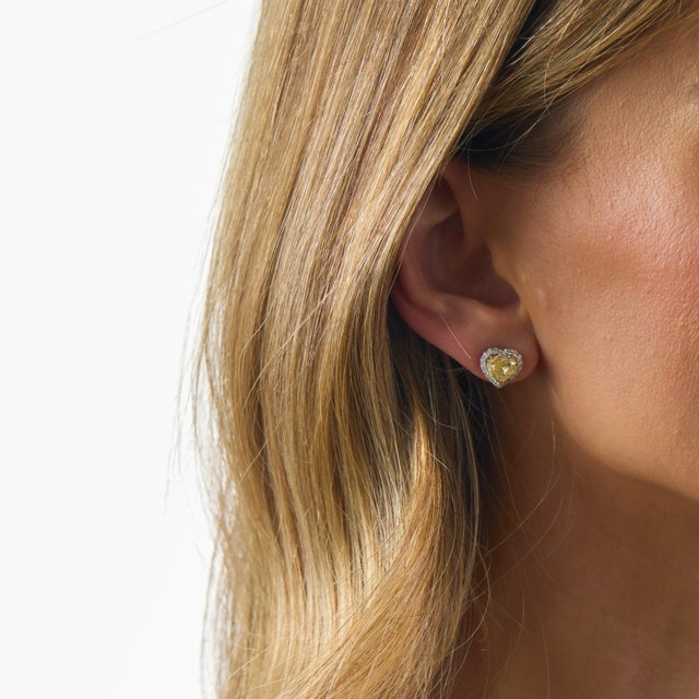 GIA 4.00 carat fancy yellow heart shape diamond 18k white gold stud earrings are an extraordinary contemporary design...