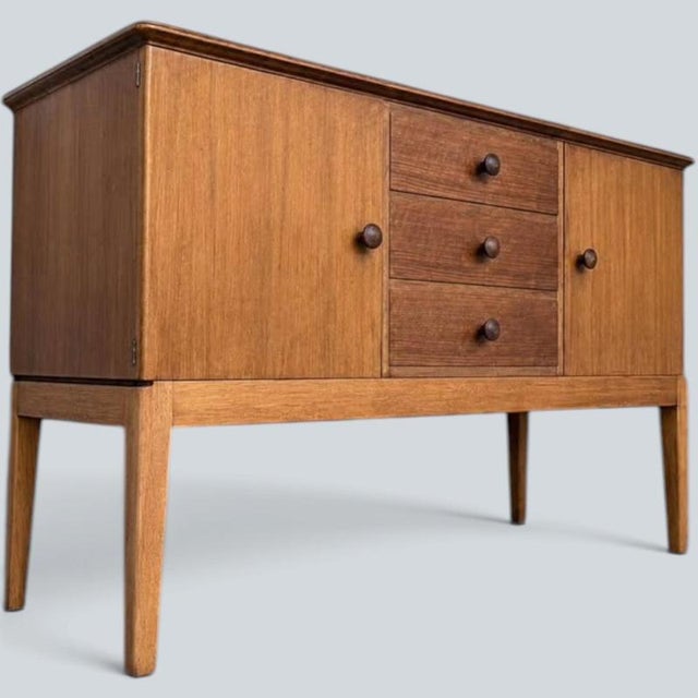 elegant mid-century sideboard by Gordon Russell of Broadway , showcasing the restrained craftsmanship and timeless...