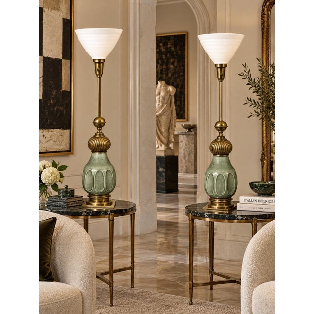 This pair of table lamps features a jade green crackle glaze ceramic body accented by intricately detailed brass elements...
