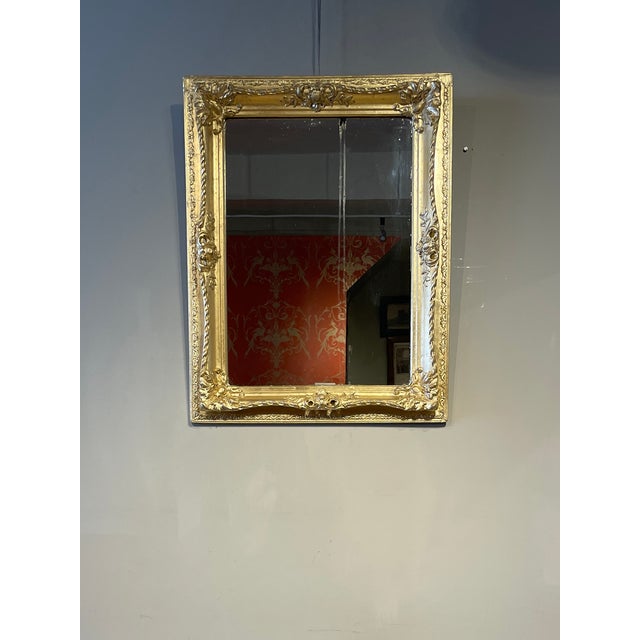 This beautiful original French Luis XVI styled gilded mirror encased in plaster has original mercury glass mirror.