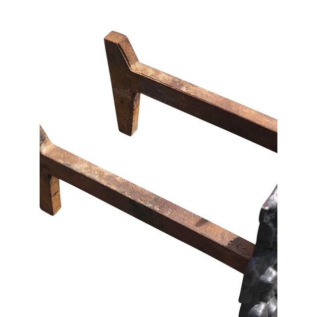 Pair of heavy cast iron dog andirons in a seated pose.