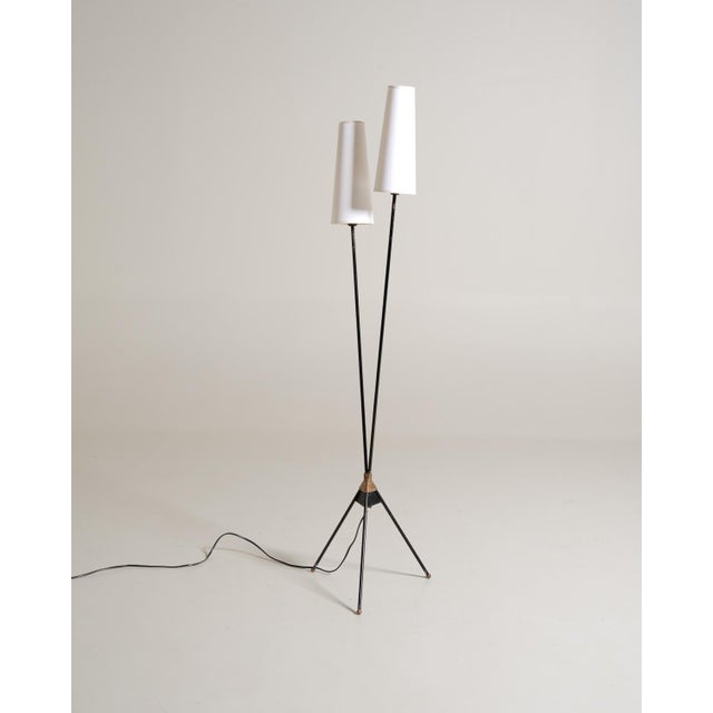 Two black-painted metal stems extend from a tripod base and terminate at different heights in conical white fabric...