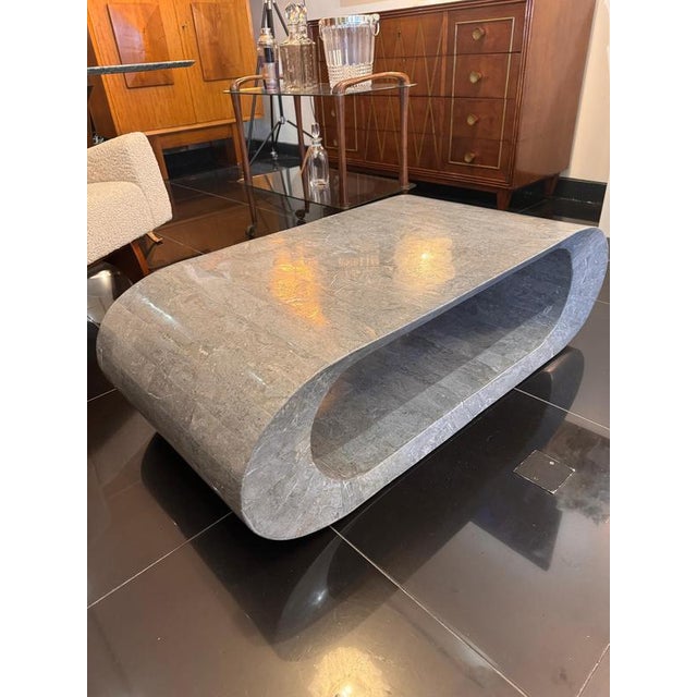 A postmodern geometric design two tiered coffee table in tessellated light grey marble . C1980 Italy