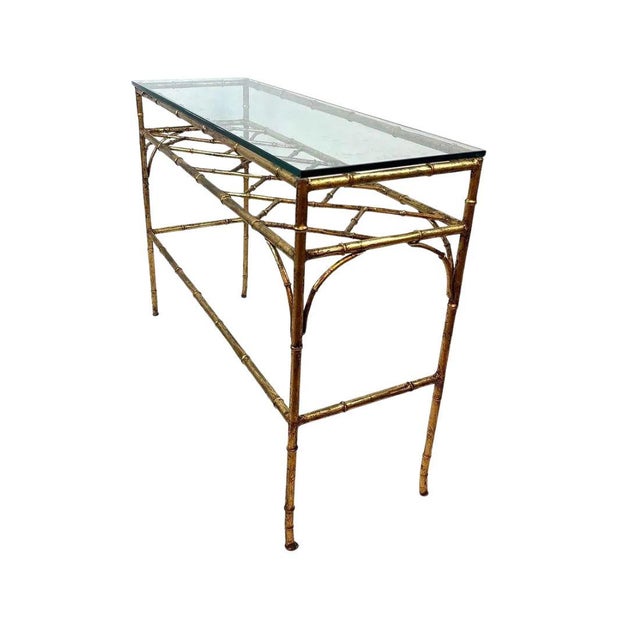A Chinese Chippendale styled faux bamboo and glass console of gold metal. A fusion of Hollywood Regency and chinoiserie...