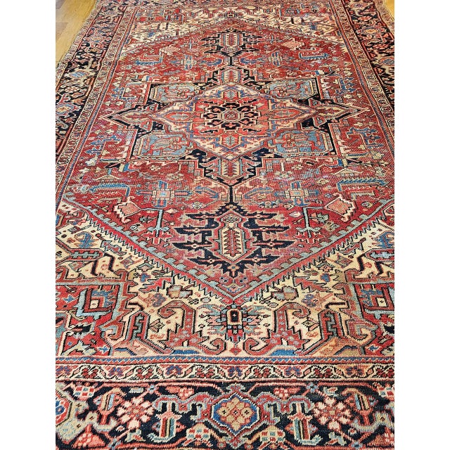 "A striking late 19th century Persian Heriz rug in the Serapi style, woven in the fourth quarter of the 1800s, reflecting...