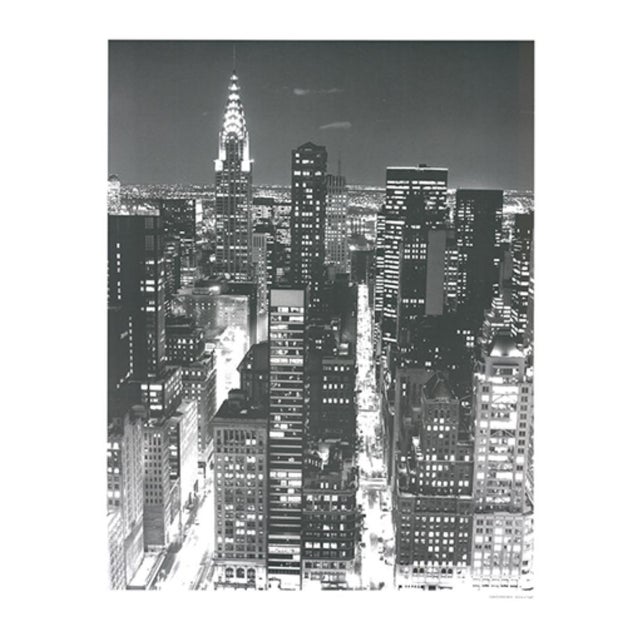 “Skyline at Night” by Christopher Bliss is a striking black-and-white cityscape art print capturing the dramatic energy...