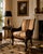 A striking Vintage mahogany armchair showcasing exceptional hand-carved craftsmanship inspired by 19th-century French...