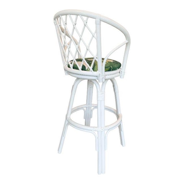 Bring effortless Palm Beach style to your kitchen or bar with this charming set of three white rattan swivel counter...