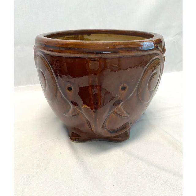 A charming mid-century ceramic elephant planter featuring sculptural relief detailing and rich brown glaze. Animal...