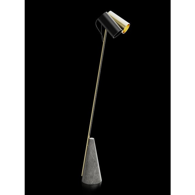 Floor lamp with grey stone base, brushed brass structure and double lightshield made in black paint and brushed brass....