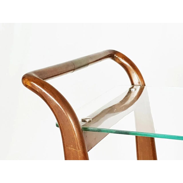 Wooden structure with glass shelf and brass handles. Overall good condition. For a similar item see the follow reference :...