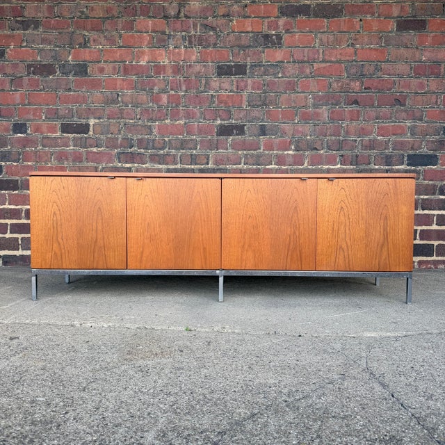 This is a Knoll International by Florence Knoll 4-door low profile teak credenza. It features 8 adjustable shelves and...