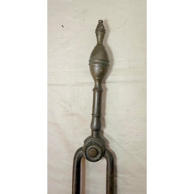 Up for sale is a nice pair of rare antique 18th century wrought iron and brass English fireplace tongs. The arms are...