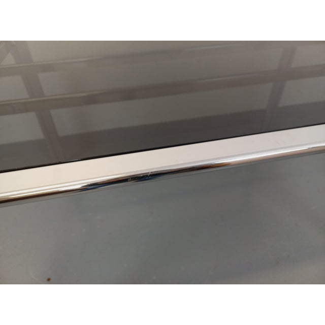 Vintage 1970s dining table, Space Age style, oval smoked glass top, chrome-plated metal base and frame. Very good overall...