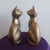 ​A striking and exceptionally substantial pair of vintage solid brass sitting cat sculptures. Reaching nearly 9 inches in...