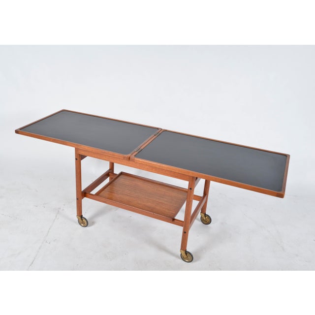 A 1960s danish two tier extending serving table / drinks trolley designed by kurt østervig for jason møbler, the solid...
