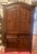 Substantial Mexican pine armoire in the Spanish Colonial/Hacienda tradition, featuring a rich dark-stained finish,...