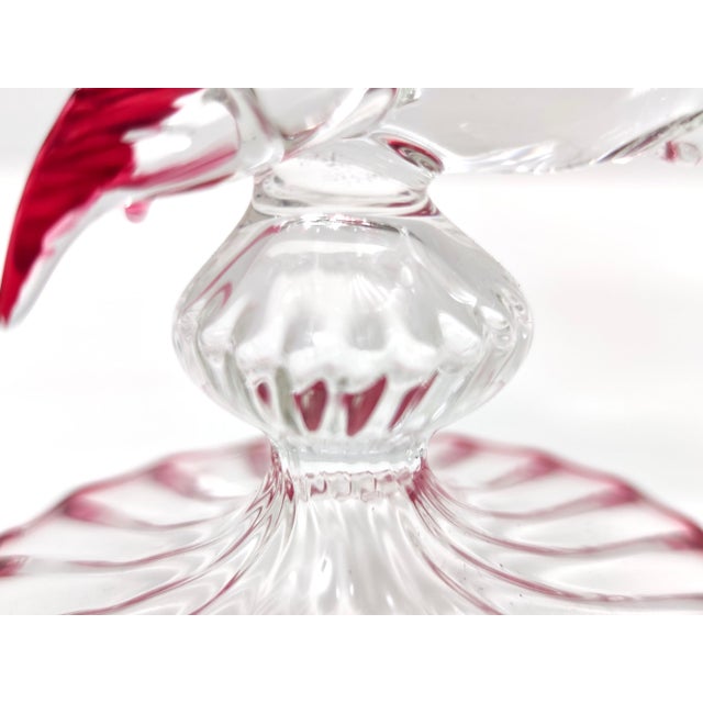 Made in Italy, 1970s - 1980s. This cake stand / pedestal bowl is made in Murano glass and features a fish-shaped stem. It...