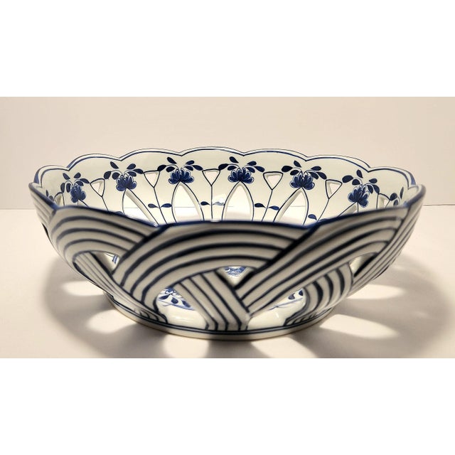 Presenting an authentic, vintage 1990s Maitland-Smith blue and white porcelain reticulated basket bowl. This exquisite...