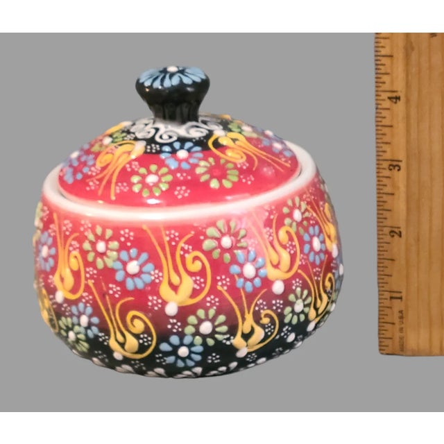 This Vintage Turkish Hand Painted Colorful Enamel Covered Jar is a beautiful addition to any collection. The porcelain...