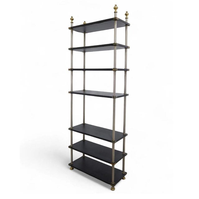 A vintage etagere of silver metal supports, gold metal finials and faux leather wrapped shelves. Seven shelves of...