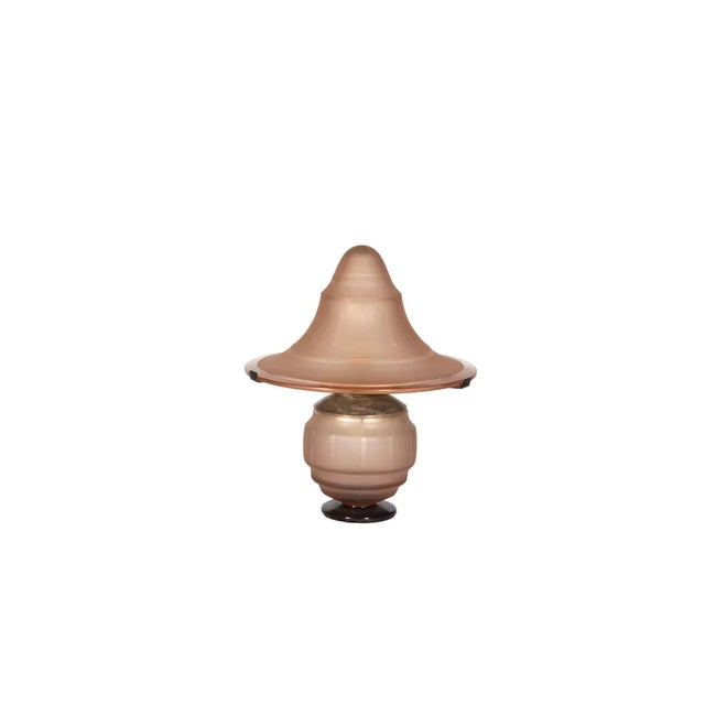 A 1930s unusual mushroom shaped table lamp with pink frosted glass and metal upper structure from the forges of Nancy....