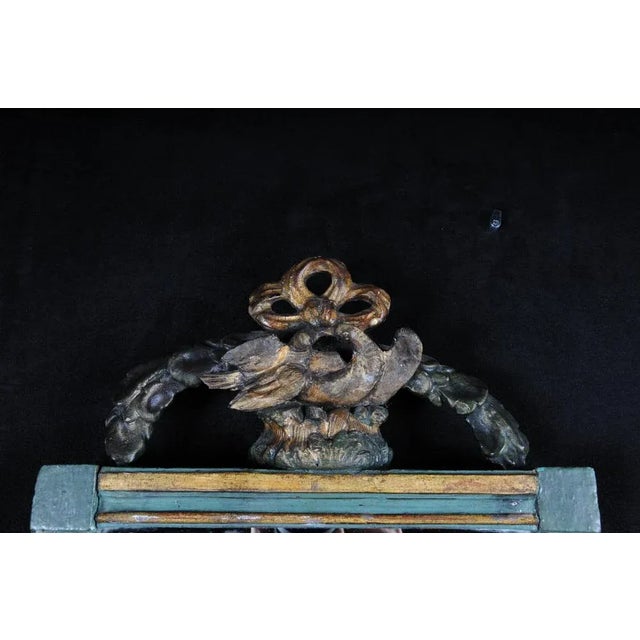 Colored and partially gilded body decorated with garlands. Original mirror glass. Museum worthy of 1780. (M-38). Wear...